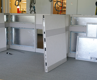 Workers install office cubicles